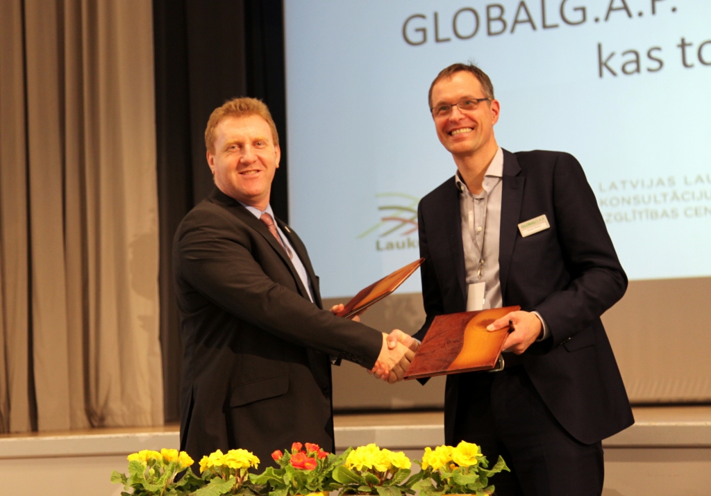LLKC valdes priekšsēdētājs Mārtiņš Cimermanis (no kreisās) un GLOBALG.A.P. prezidents Kristians Moellers paraksta sadarbības līgumu